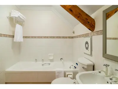 a bathroom with a tub and a toilet and a sink at Protea Hotel by Marriott Cape Town Mowbray in Cape Town