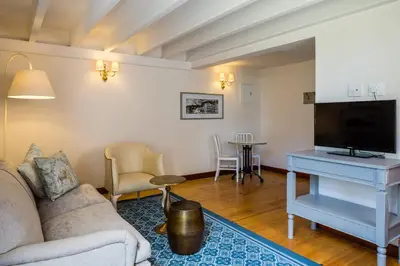 a living room with a couch and a tv at Protea Hotel by Marriott Cape Town Mowbray in Cape Town