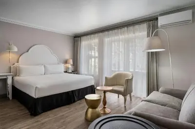 a hotel room with a bed and a couch at Protea Hotel by Marriott Cape Town Mowbray in Cape Town