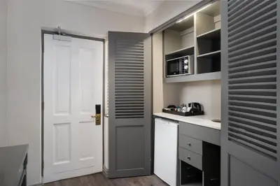 a kitchen with a white door and a white counter at Protea Hotel by Marriott Cape Town Mowbray in Cape Town
