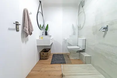 a bathroom with a toilet and a sink and a shower at Luxury Beachfront Apartment in Blouberg, 304 The Waves in Bloubergstrand