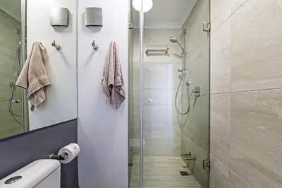 a bathroom with a shower with a glass door at Luxury Beachfront Apartment in Blouberg, 304 The Waves in Bloubergstrand