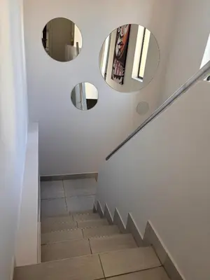 a staircase with three mirrors on the wall at Modern 3 bedroom Urban Getaway in Cape Town