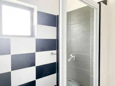 a bathroom with a toilet and a glass shower at Coastal Beach & Mountain Retreat in Cape Town