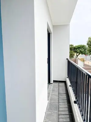 a hallway of a white building with a balcony at Coastal Beach & Mountain Retreat in Cape Town
