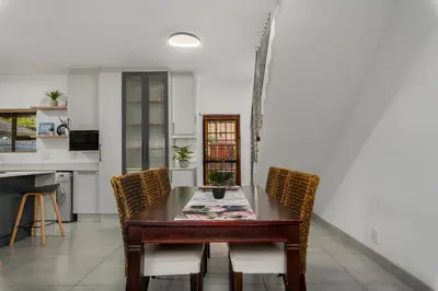 a kitchen and dining room with a table and chairs at Tafelzicht Peaceful Retreat - Wifi - Netflix in Cape Town