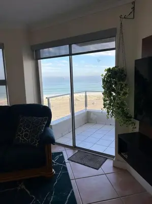 a living room with a view of the ocean at Nautica by the Beach in Cape Town