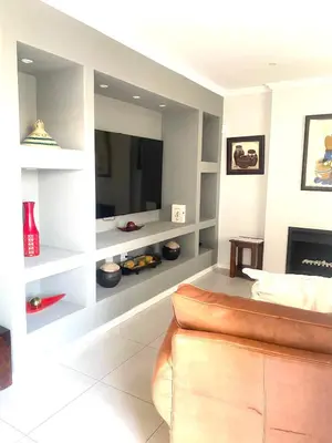a living room with a tv and a couch at Five bedrooms holiday home in Cape Town