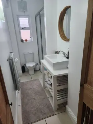 a white bathroom with a sink and a toilet at No 4 Life at Sea in Strand