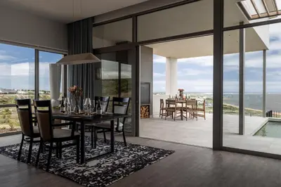 a dining room with a table and chairs at Azure Retreat in Hermanus