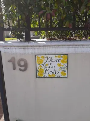 a sign on a wall with a sign with a new year sign at Klein La Cotte Garden Cottage in Franschhoek