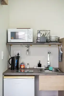 a kitchen counter with a microwave and a sink at House of joy in Cape Town
