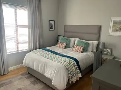 a bedroom with a bed with two pillows on it at Divine View in Cape Town