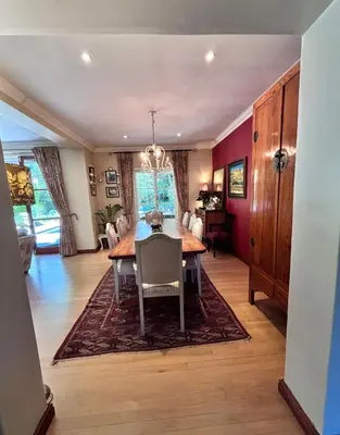 a dining room with a table and chairs at Garden oasis in the village in Franschhoek
