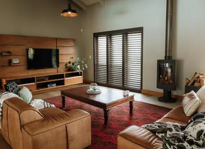a living room with a couch and a coffee table at 13 Olives, Entire Grape & Olive Estate, Somerset West by Euphoric Leisure in Sir Lowryʼs Pass