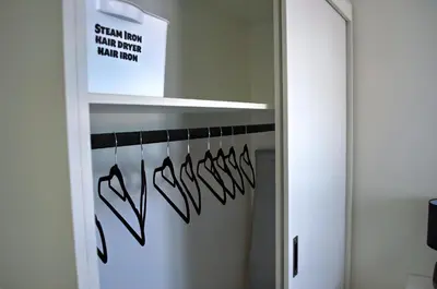 a closet with a mirror and a sign on the door at Camden Stay - Entire Unit - Cape Town in Cape Town