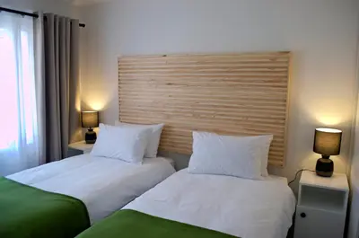 two beds sitting next to each other in a room at Camden Stay - Entire Unit - Cape Town in Cape Town