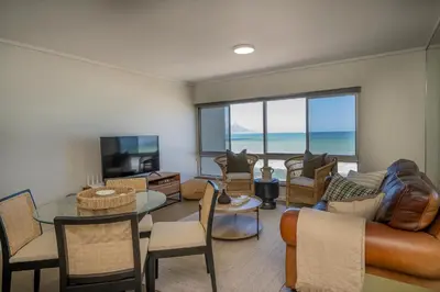 a living room with a view of the ocean at 2 Bedroom Apartment - Blouberg Beachfront in Cape Town
