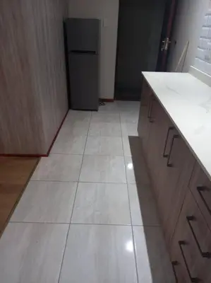 a kitchen with a counter and a refrigerator at Entire Spacious Guest suite in Cape Town in Cape Town