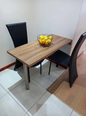 a wooden table with a bowl of fruit on it at Entire Spacious Guest suite in Cape Town in Cape Town