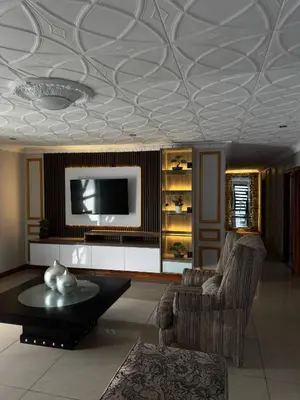a living room with a coffered ceiling and a tv at Luxurious 4 bedroom Family Home in Cape Town