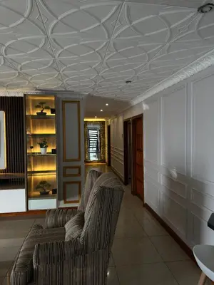 a living room with two chairs and a coffered ceiling at Luxurious 4 bedroom Family Home in Cape Town