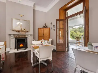 a dining room with a table and a fireplace at The Huts - Glamping at Caledon Grace in Caledon