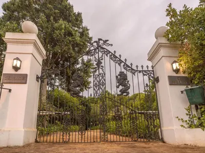 a gate at the entrance to a park at The Huts - Glamping at Caledon Grace in Caledon