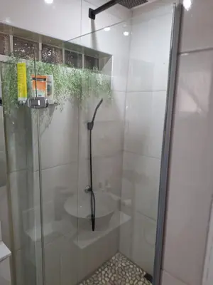 a shower with a glass door in a bathroom at Cosy Cottage Cape Town in Cape Town