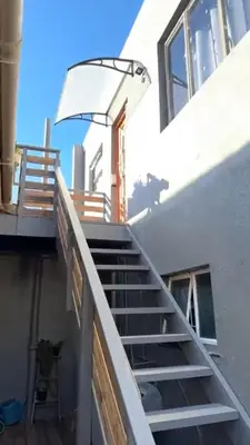 a set of stairs leading up to a building at Ocean Breath Apartment in Strand