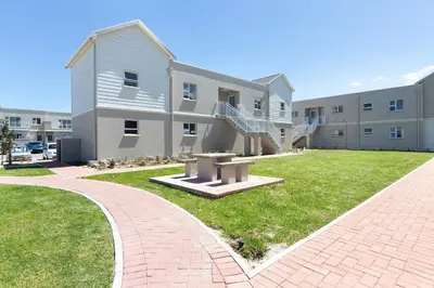 a brick walkway in front of a building at Elegant apartment near beach in Cape Town