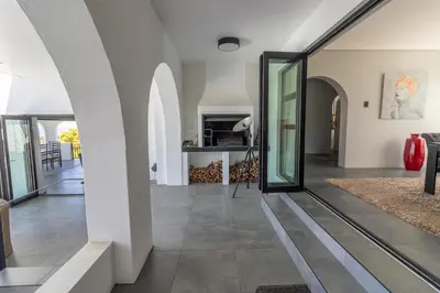 a pivot door in a house with a living room at Waveren's Nest in Cape Town