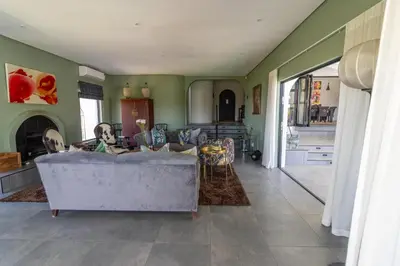 a living room with a couch and a table at Waveren's Nest in Cape Town
