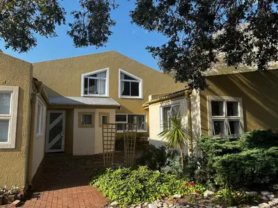 a yellow house with at Voëlklip Holiday Home in Hermanus