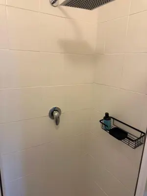 a bathroom with a shower with a soap dispenser at Casa on Alamein in Cape Town
