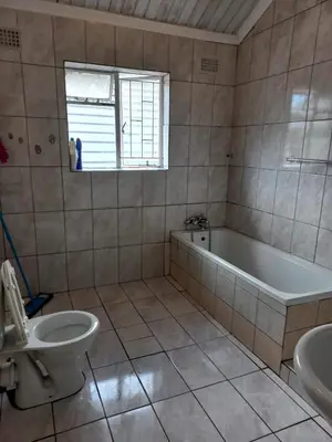 a bathroom with a tub and a toilet and a sink at Transvaal Road, N1 in Worcester