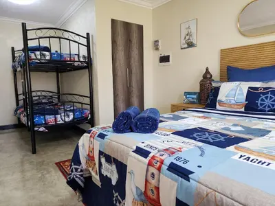 a bedroom with a bed and a bunk bed at The Seagull in Cape Town