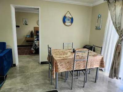 a dining room with a table and chairs in a room at The Seagull in Cape Town