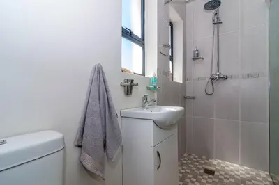 a white bathroom with a sink and a toilet at SeaB by Top Destinations Rentals in Hermanus