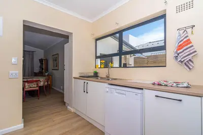 a kitchen with a sink and a large window at SeaB by Top Destinations Rentals in Hermanus