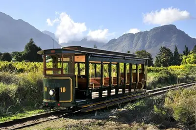 an old trolley car on the tracks in a field at Village Artisan Franschhoek in Franschhoek