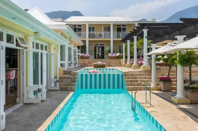 a swimming pool in the courtyard of a house at Birkenhead House in Hermanus