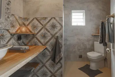 a bathroom with a toilet and a sink at YEBO Boutique Guesthouse in Somerset West