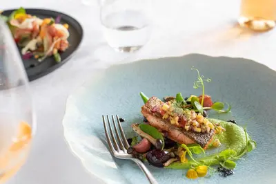 a plate of food with meat and vegetables on a table at La Residence in Franschhoek