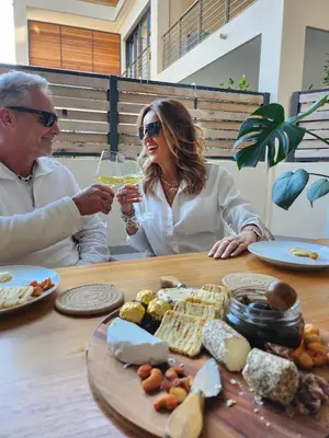 a man and woman sitting at a table drinking wine at 111 at The Esplanade in Hermanus