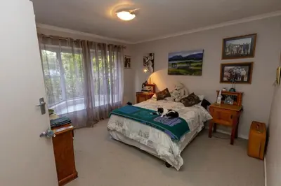 a bedroom with a bed with two dogs on it at 3 Bedroom part house in the scenic Durbanville wine lands area, holiday facility in Cape Town