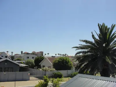 a palm tree and houses in a residential neighborhood at 113 Reasons Self Catering in Cape Town