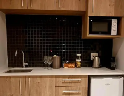 a kitchen counter with a sink and a microwave at C'est la Vie 5 Garden View Apartment in Franschhoek