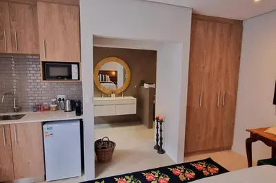 a kitchen with a white refrigerator and a mirror at C'est la Vie 6 Standard Apartment in Franschhoek