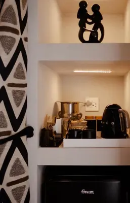 a kitchen with a stove and a pot on a shelf at Zeven Eike Homestead in Stellenbosch